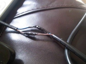 DIY cable repaired with just insultation tape - very high risk in school environment.