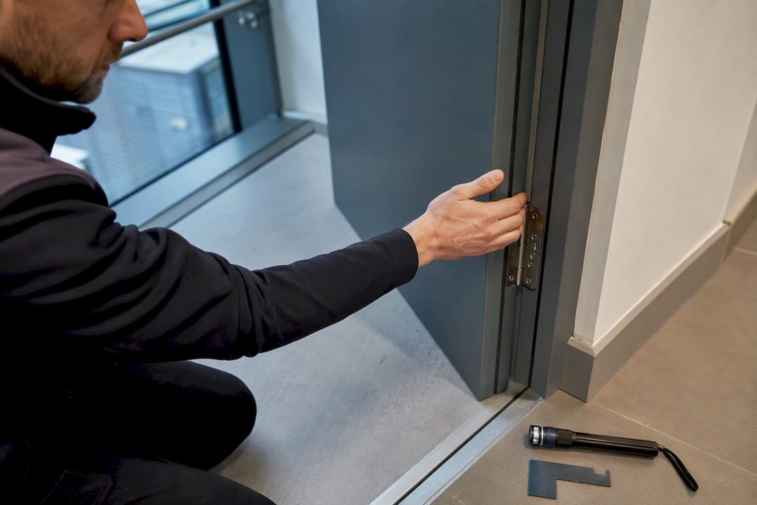 Assessor checking commercial fire door condition